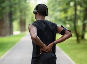 back view of black man in sportswear touching inju 2022 12 16 07 28 18 utc scaled